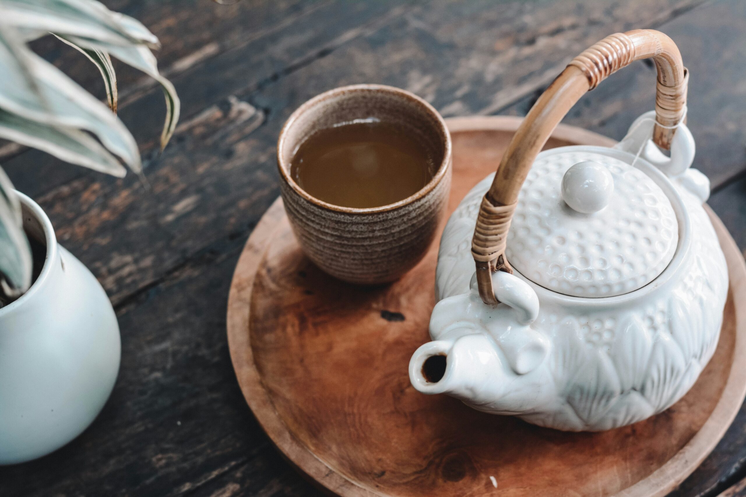 A teapot and two cups on a beautiful wooden tray