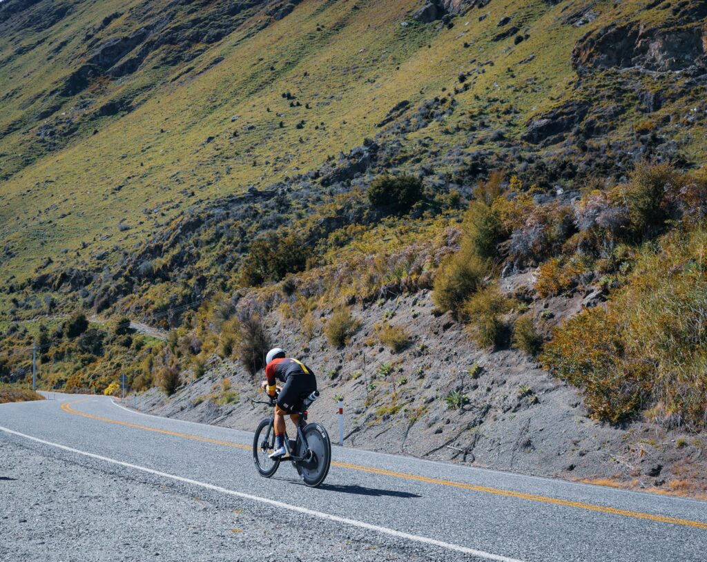 A person on a bicycle with his back to the viewer
