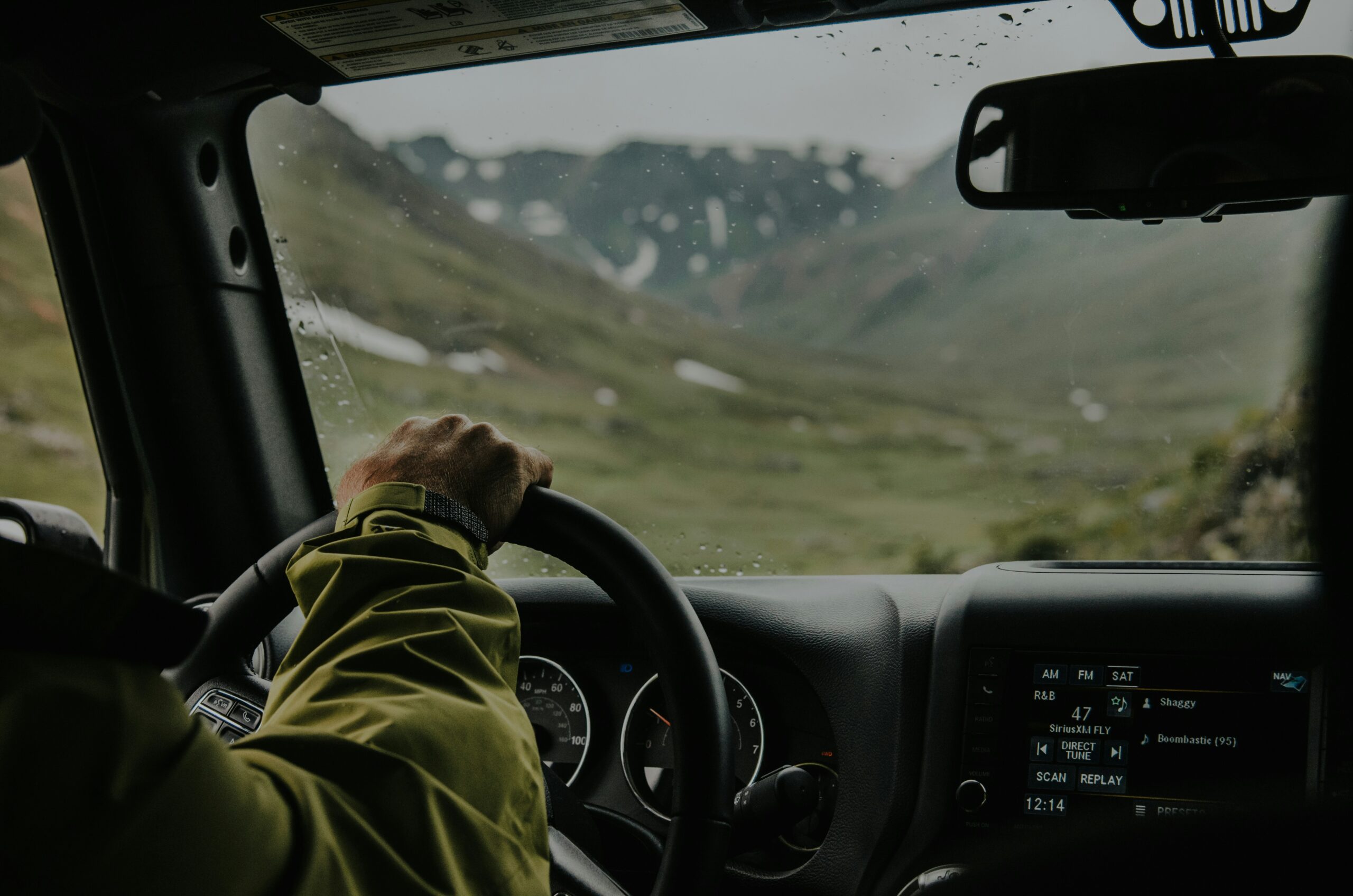 Two female hands at the wheel of a car